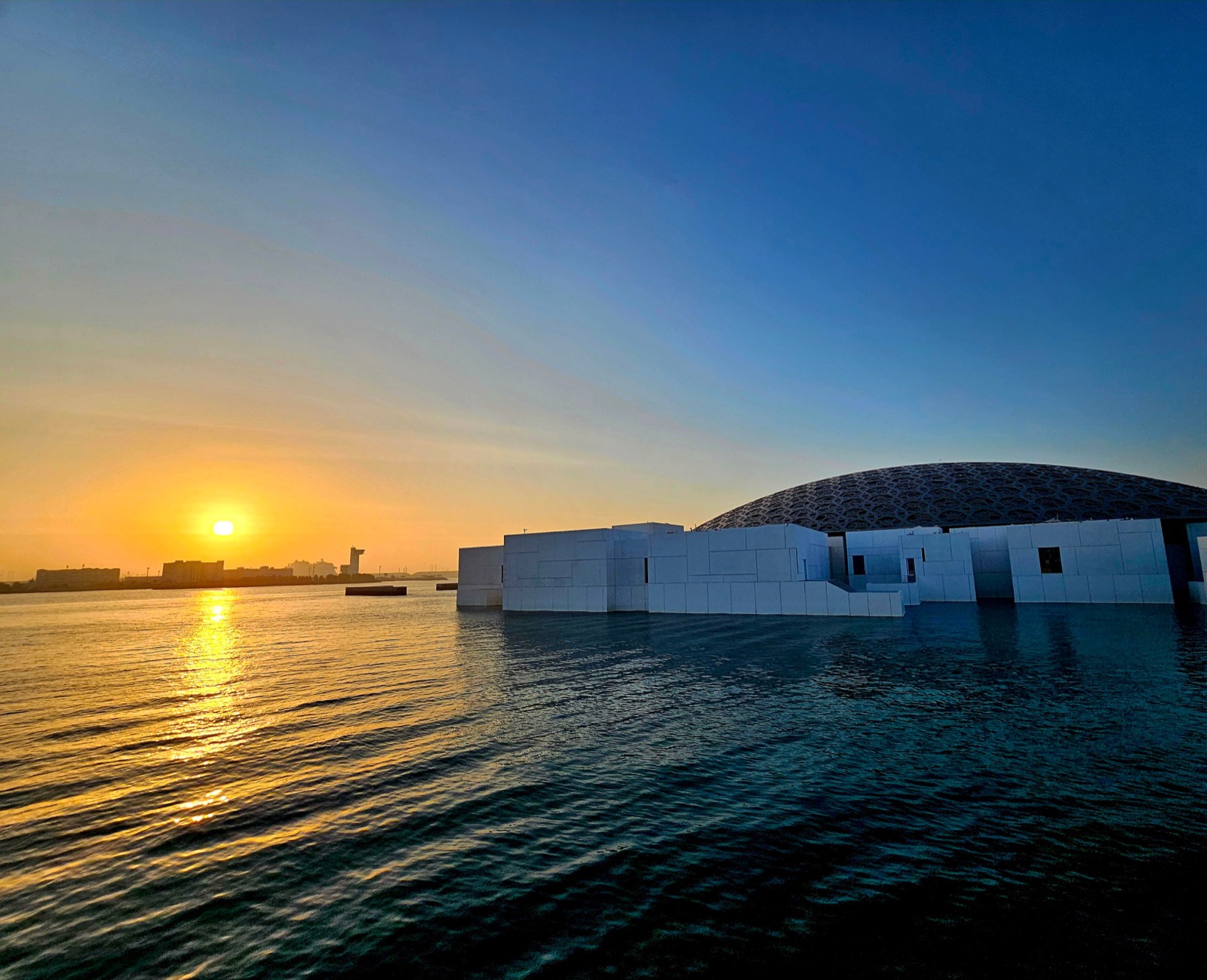 The dome of Louvre Abu Dhabi at sunset